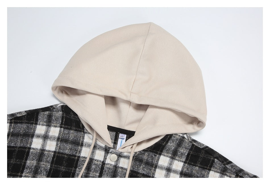 Close-up of a cream hood and drawstrings above a black, gray, and cream plaid garment.