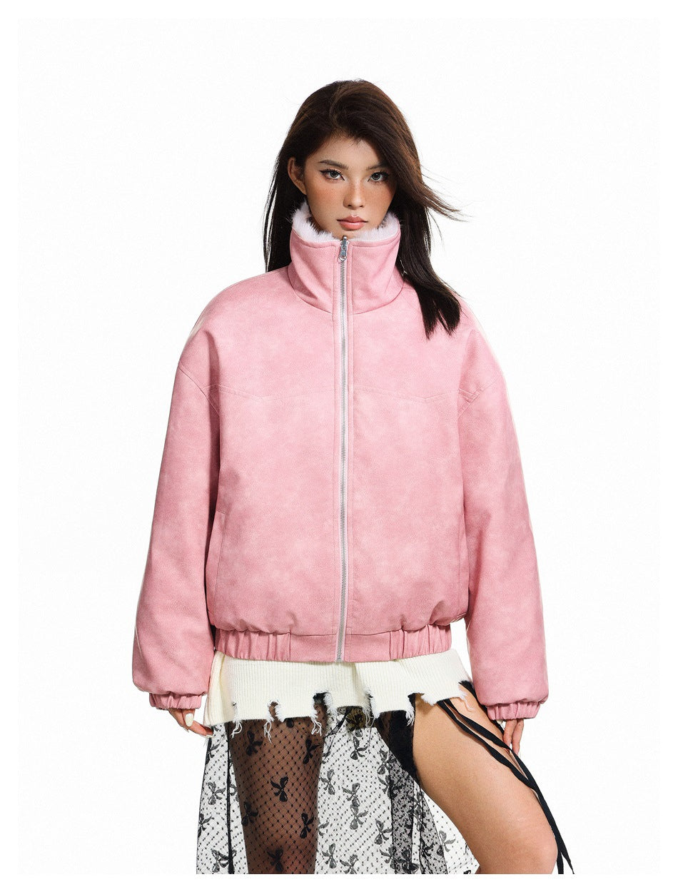 Model wearing a dusty pink jacket zipped to its high collar, with elastic cuffs and hem.