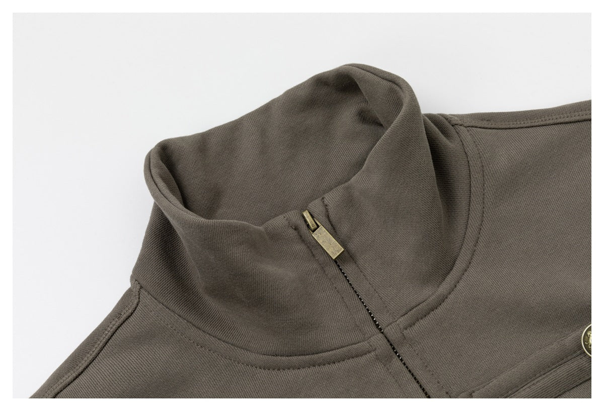 Close-up of the jacket’s stand collar, front zipper, and brass zipper pull.