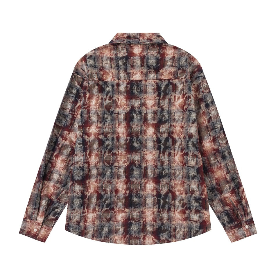 Back view of a long-sleeve button-up shirt in a distressed abstract pattern of charcoal, brown, cream and muted red.