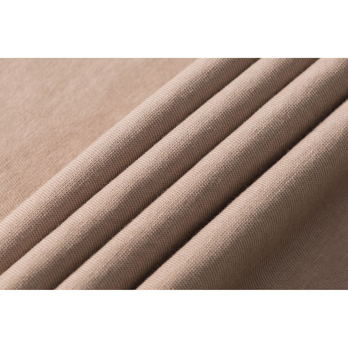Close-up of taupe knit fabric arranged in soft folds.