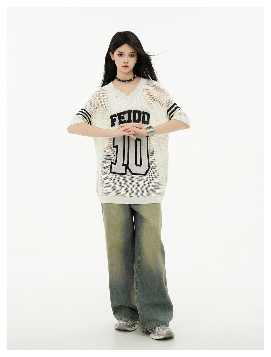 Model wearing an oversized ivory mesh-knit V-neck jersey with black sleeve stripes and FEIDD 10 lettering, paired with