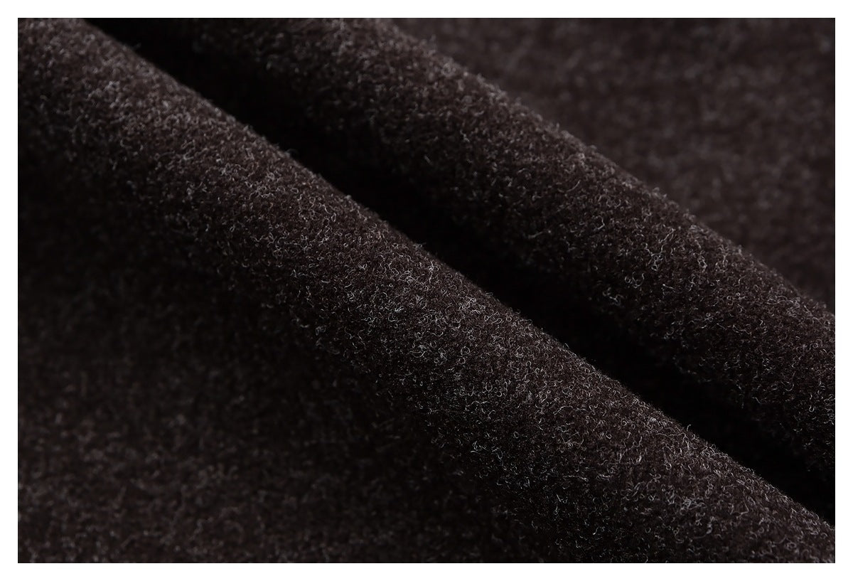 Macro view of the dark brown jacket fabric draped into a fold.