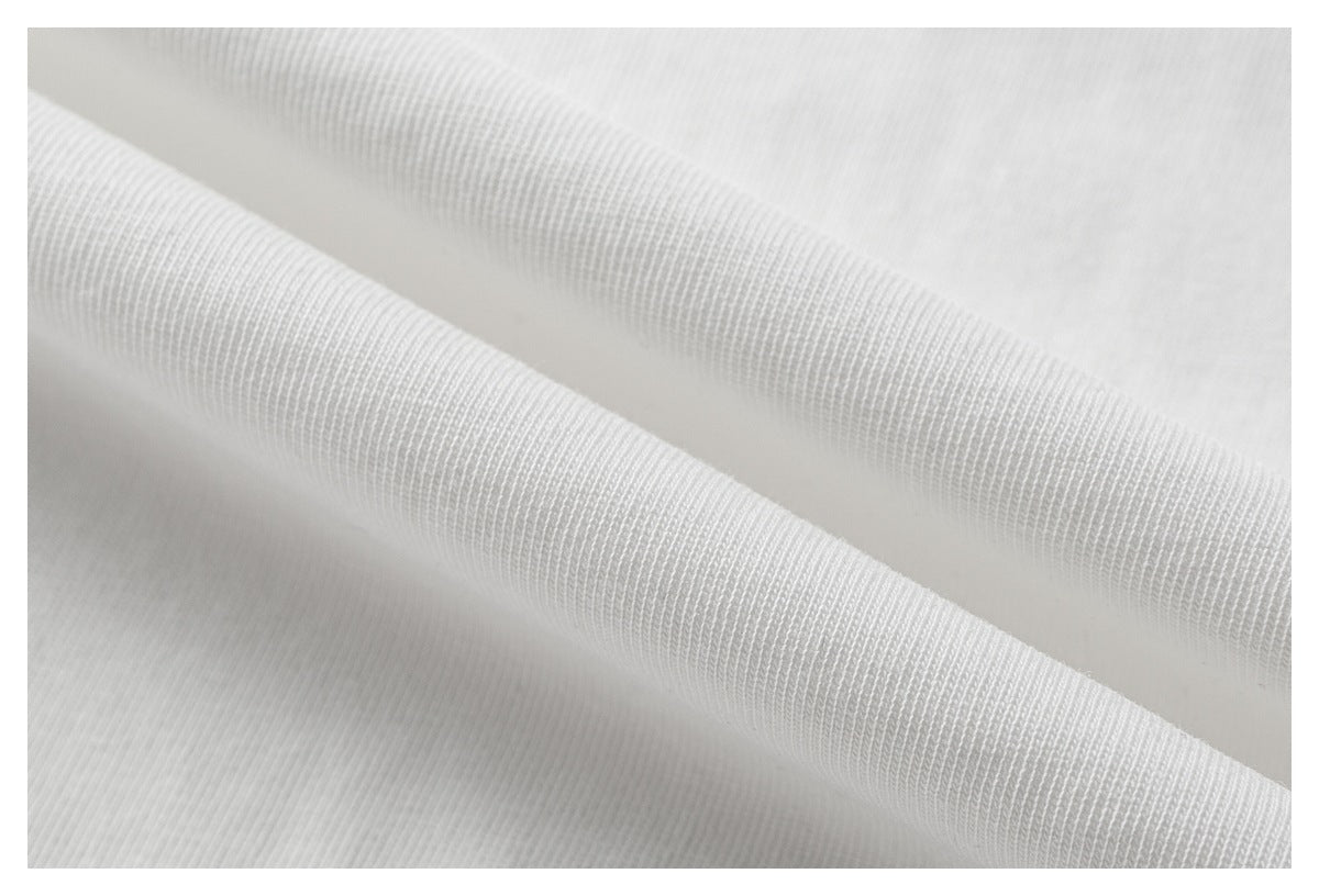 Macro view of white T-shirt fabric folded to show its knit texture.