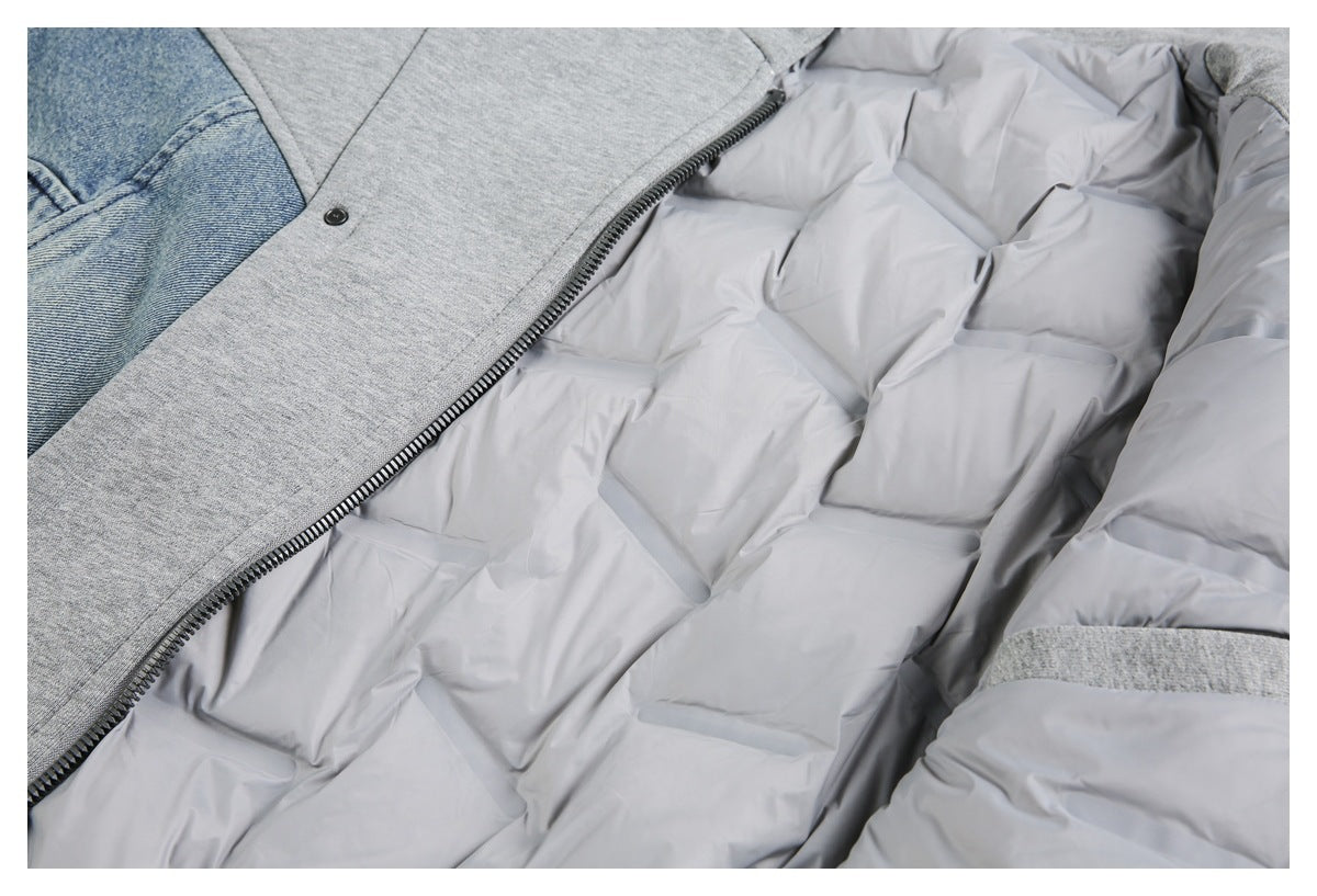 Open gray jacket close-up showing quilted lining, a front zipper, gray knit panels, and blue denim detail.