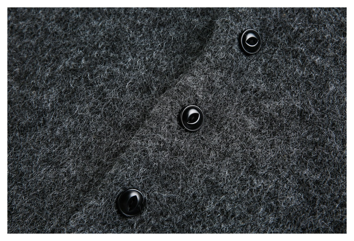 Close-up of three black buttons against charcoal gray fuzzy knit fabric.
