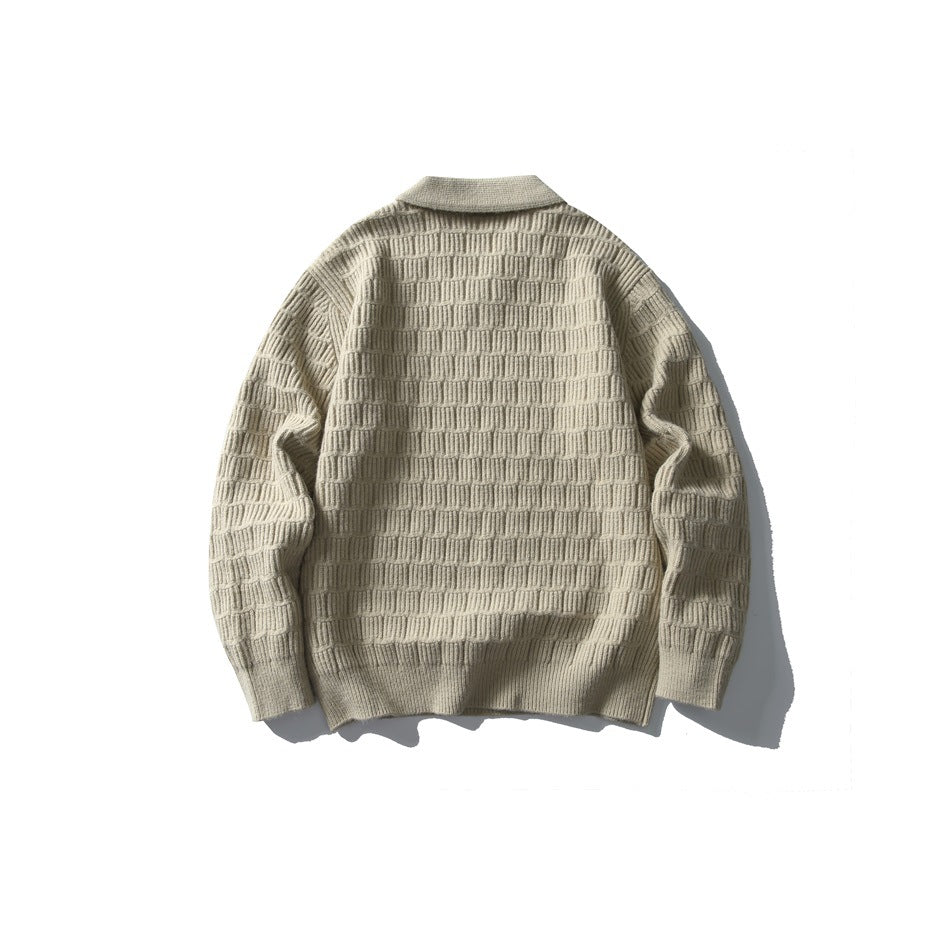 Back view of a light beige collared knit sweater with a raised rectangular stitch pattern.