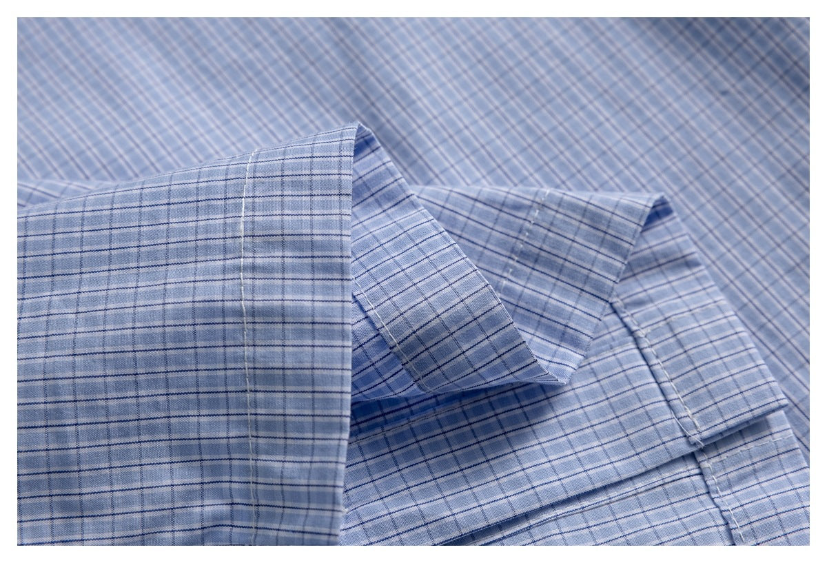 Close-up of the blue-and-white check shirt's folded collar and stitching.