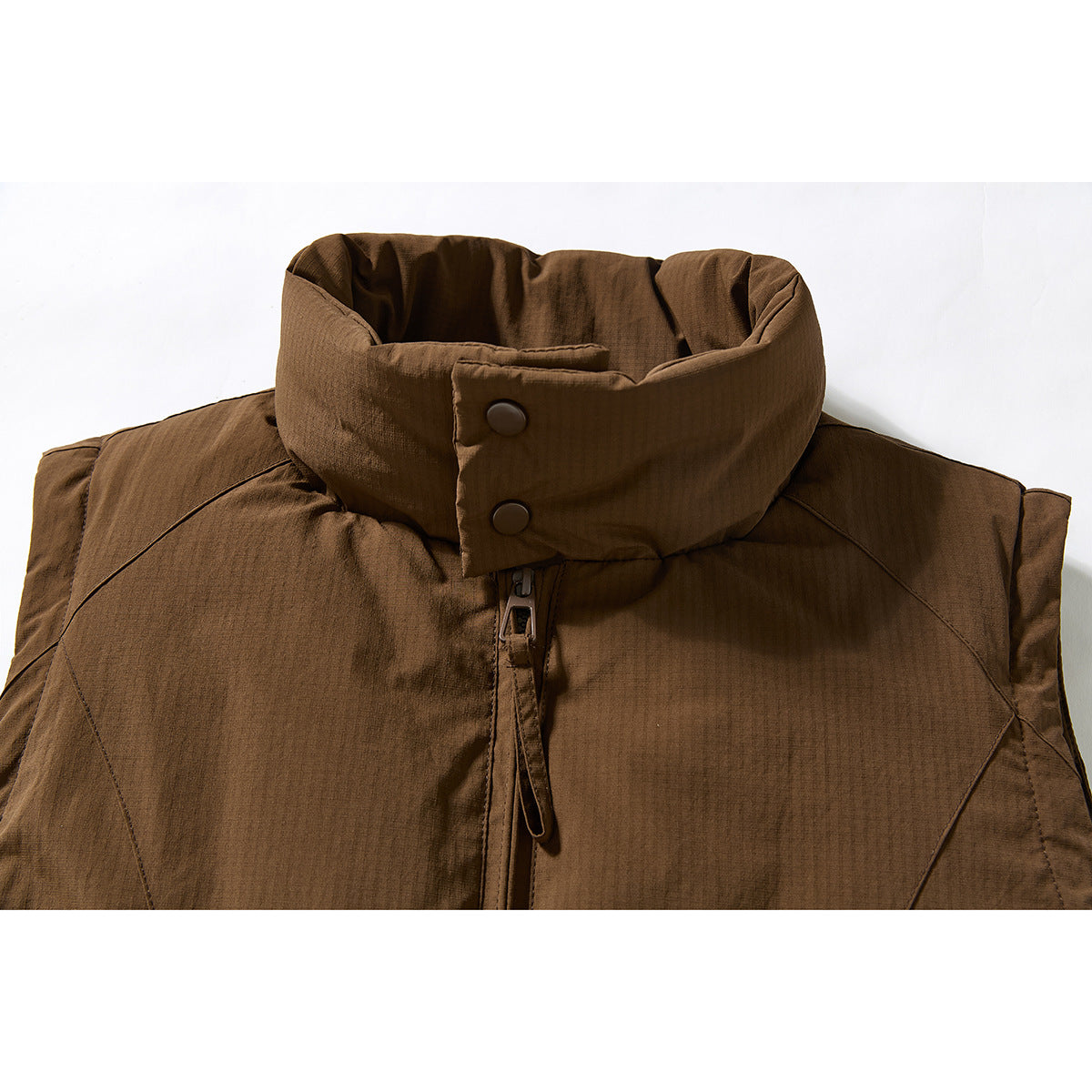 Close-up of a brown vest's high stand collar, snap buttons, and front zipper.