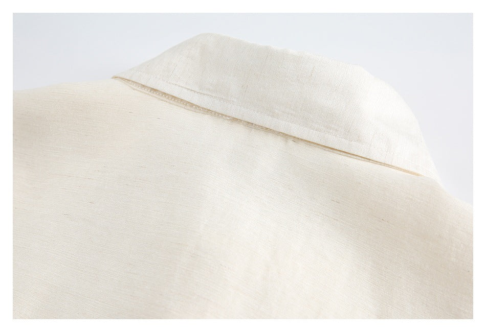 Close-up of the ivory shirt's collar and upper back seam.