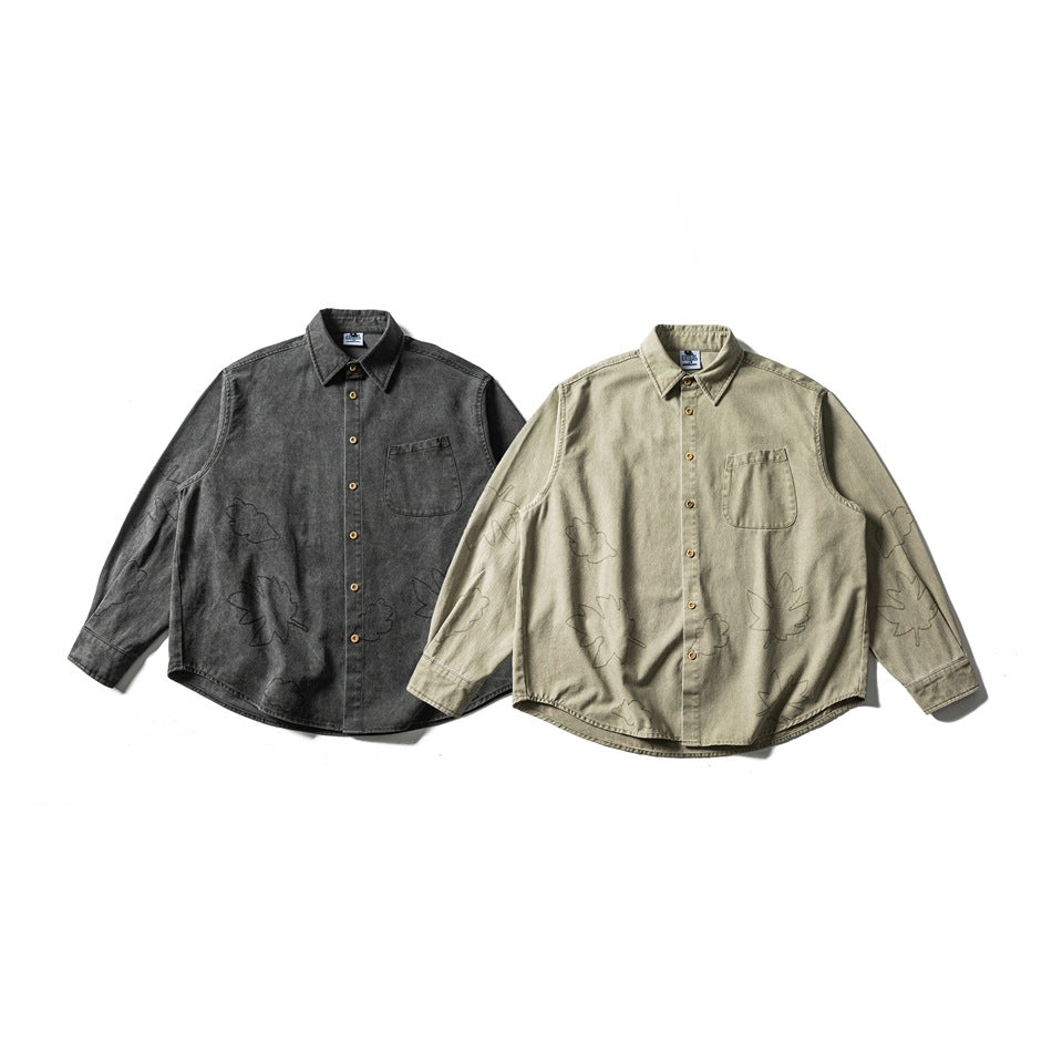 Two long-sleeve button-up shirts in charcoal and olive-gray, with chest pockets and subtle leaf outlines.