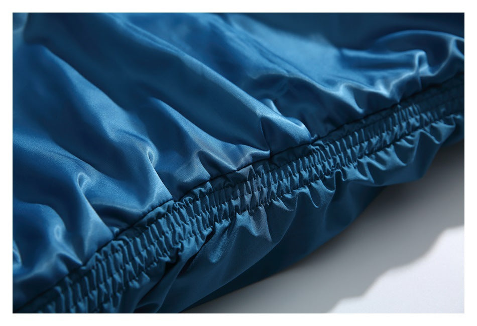 Close-up of the blue jacket's gathered elastic hem and shiny lining.