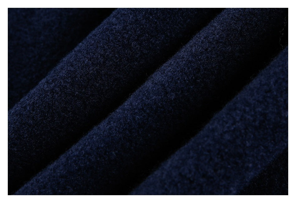 Macro view of the dark navy garment's soft, textured surface and folds.