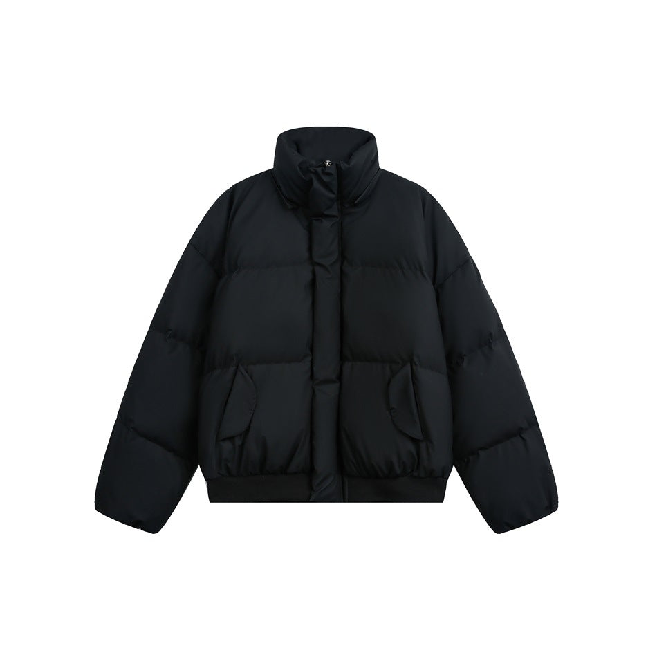 Front view of a black puffer jacket with a tall collar, snap-covered front closure, side pockets, and ribbed hem.