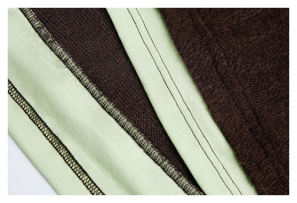 Close-up of pale green and dark brown fabric layers showing overlocked seams and stitching.