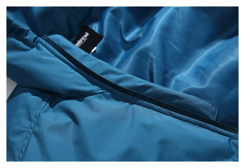 Interior close-up of the blue jacket showing a zipper and a small black sewn-in label.