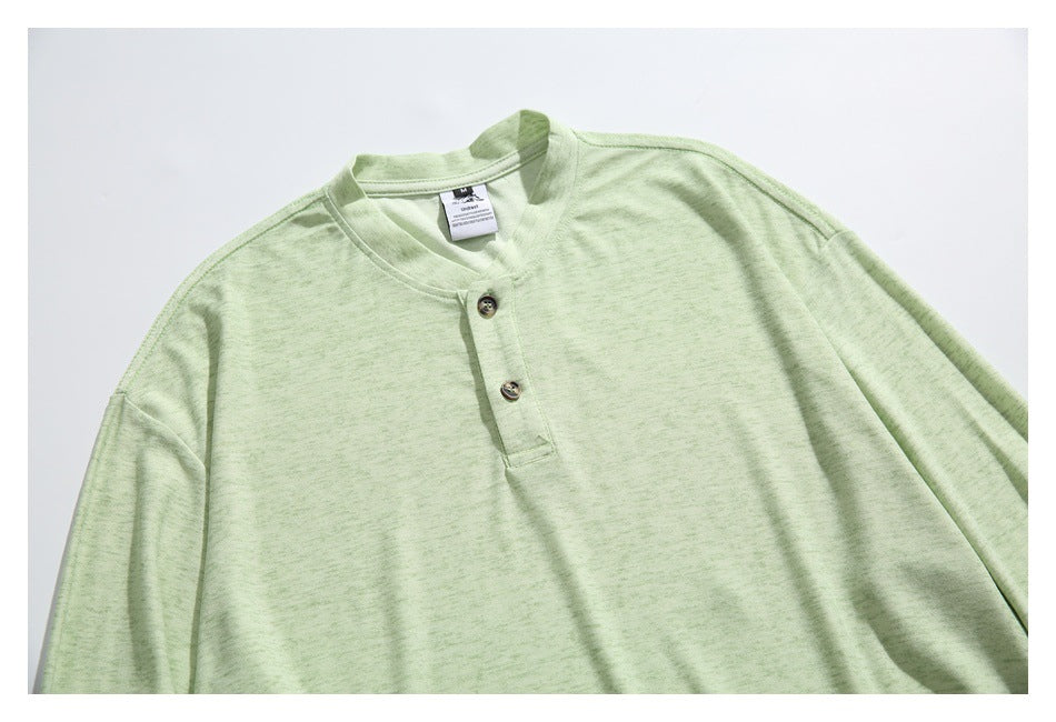 Pale green long-sleeve shirt laid flat, showing its two-button band collar and upper front.