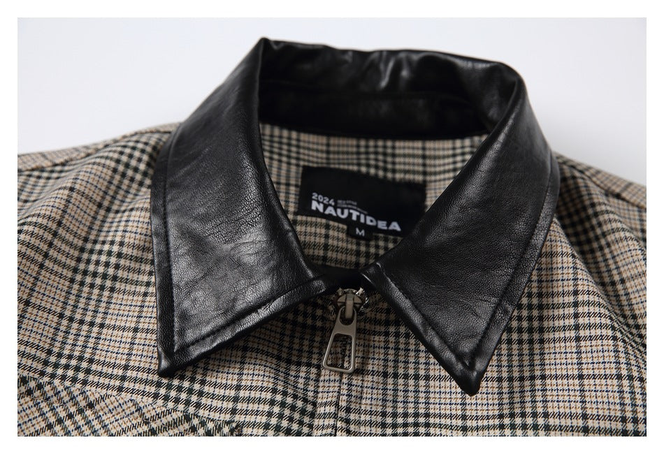 Close-up of the shirt's black pointed collar, front zipper pull and sewn neck label.