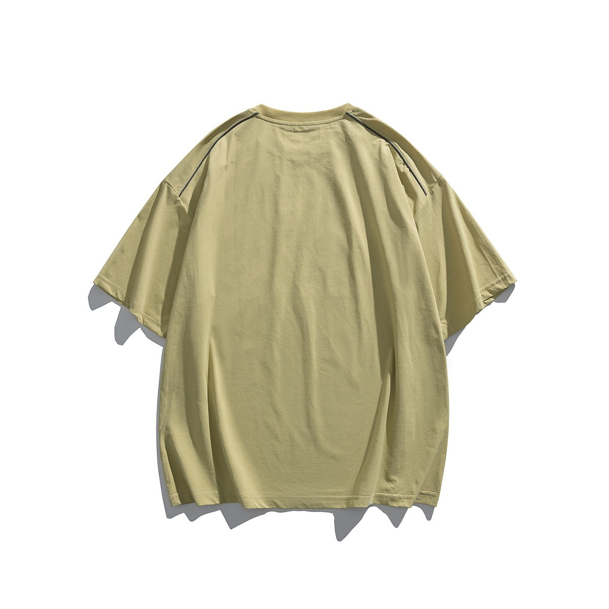 Back view of a pale khaki short-sleeve T-shirt with dark piping along the raglan shoulder seams.