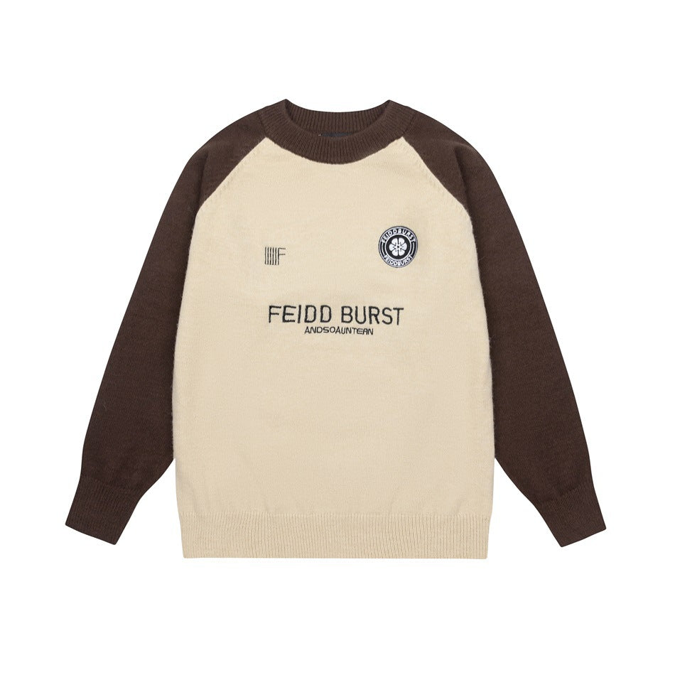 Beige crewneck sweater with brown raglan sleeves, ribbed trim and embroidered chest lettering and emblem, flat lay