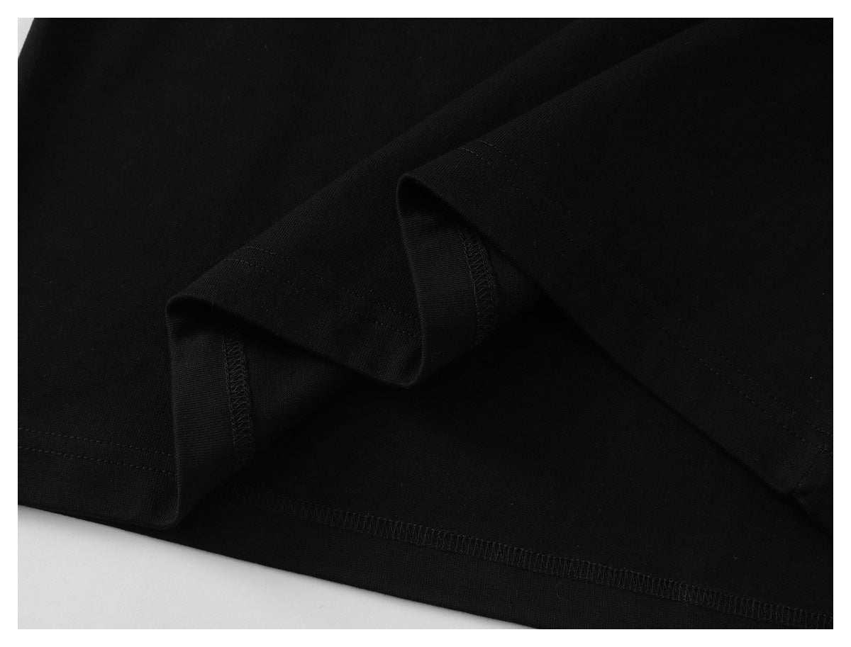Close-up of the black shirt's folded edge and overlocked stitching.