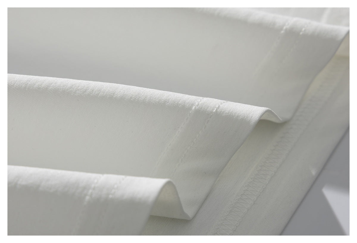 Close-up of a white garment hem with parallel stitching and an overlocked seam.