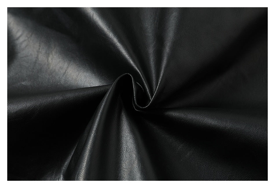 Black pebbled material gathered into a swirl, showing its surface and folds.