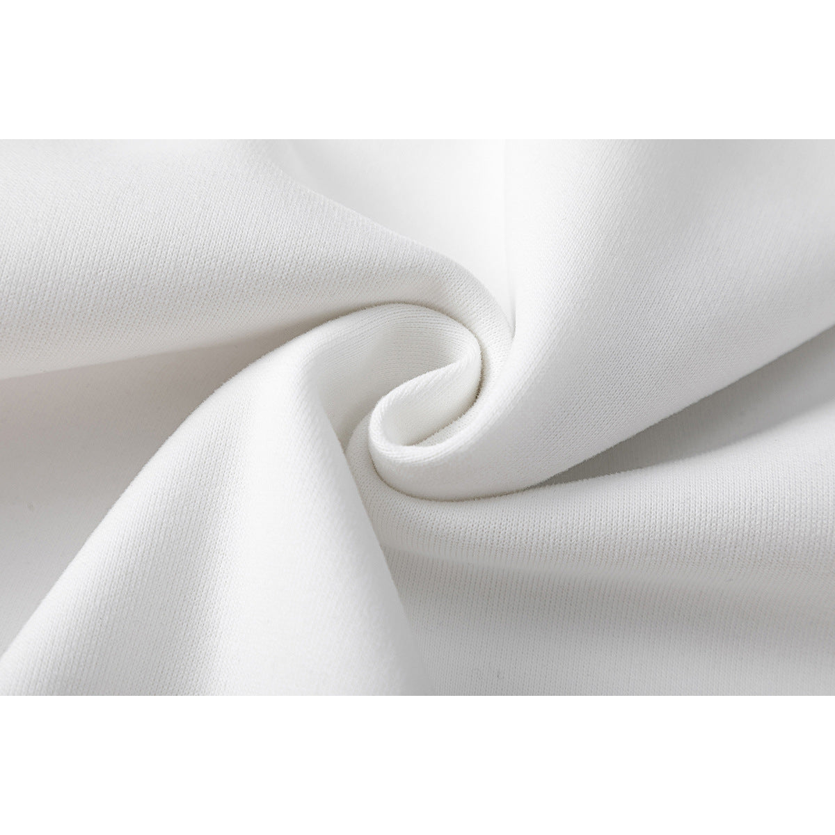 Close-up of white sweatshirt fabric gathered into soft folds, showing its knit texture.