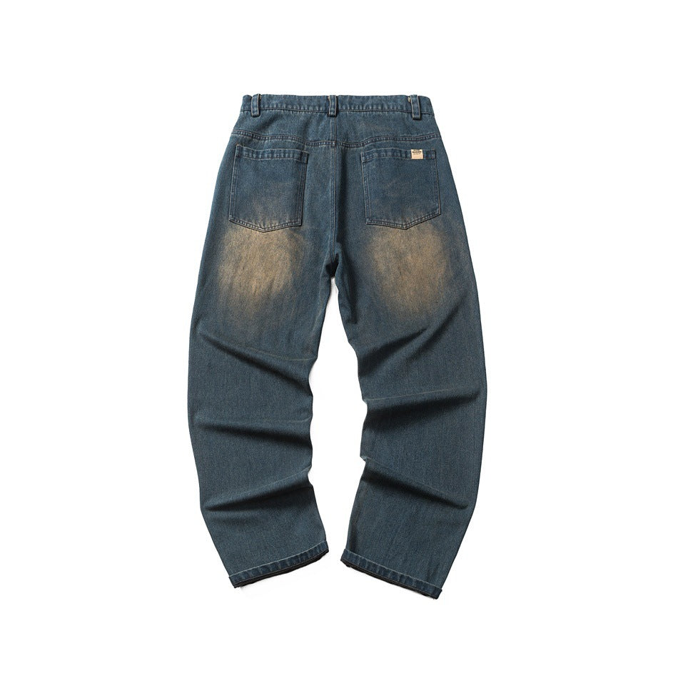 Back of blue washed denim jeans with two patch pockets, belt loops and faded tan wash on the seat