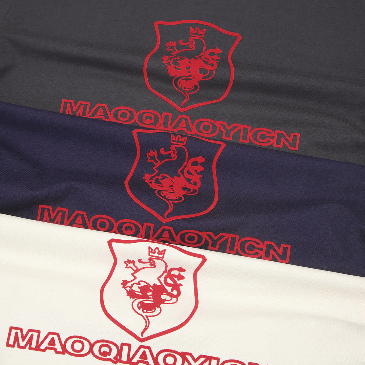 Close-up of gray, navy, and ivory shirt fabric with matching red shield and wordmark prints.