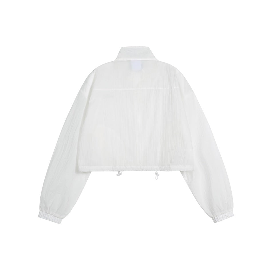 Back view of a white cropped jacket with a stand collar, long sleeves, elastic cuffs and adjustable hem.