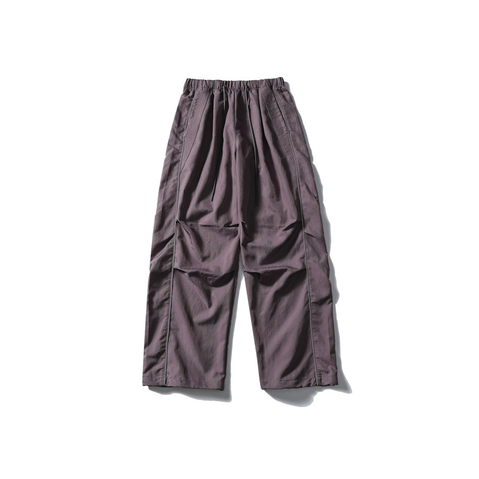 Muted purple wide-leg drawstring pants with side piping and knee pleats, flat lay front view