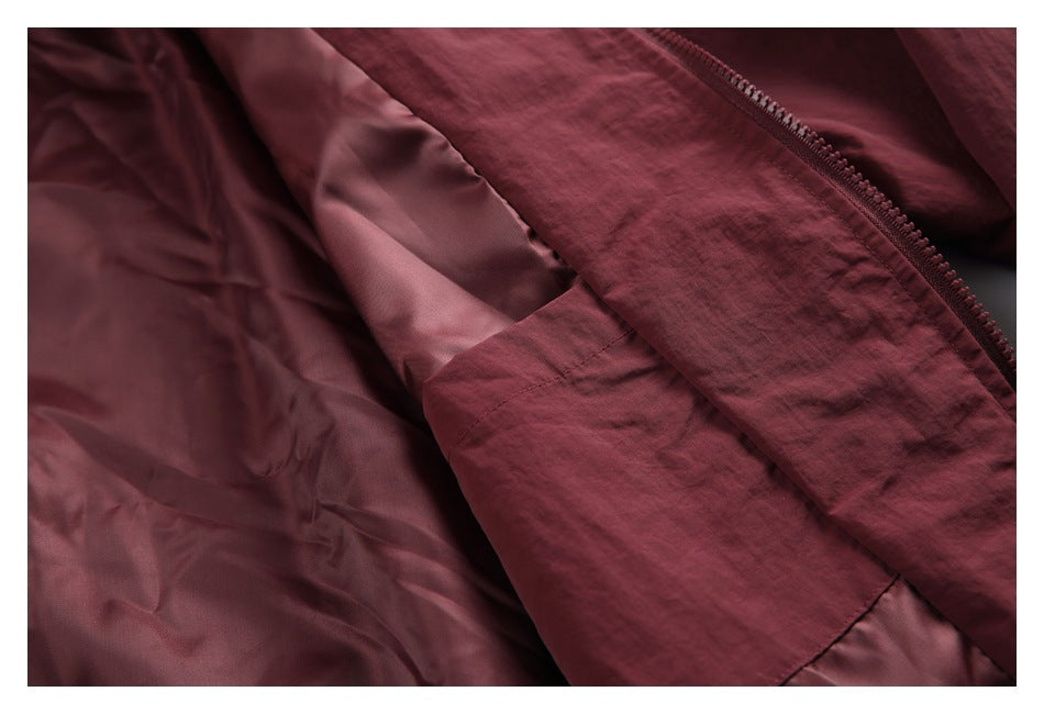 Burgundy jacket opened to show its smooth inner lining and front zipper.