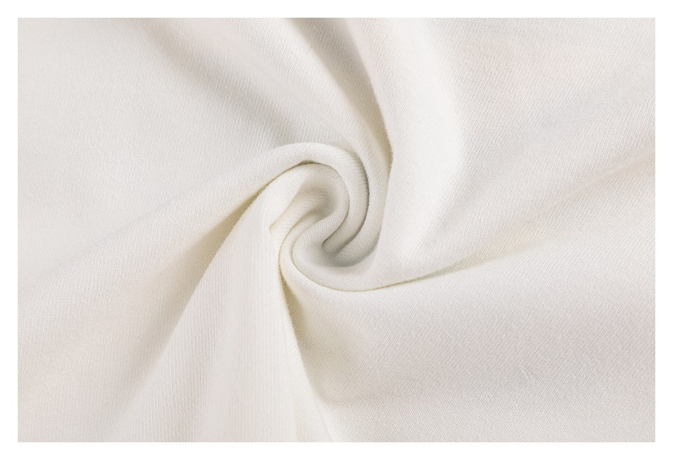 Close-up of off-white fabric twisted into a spiral, showing its surface and drape.