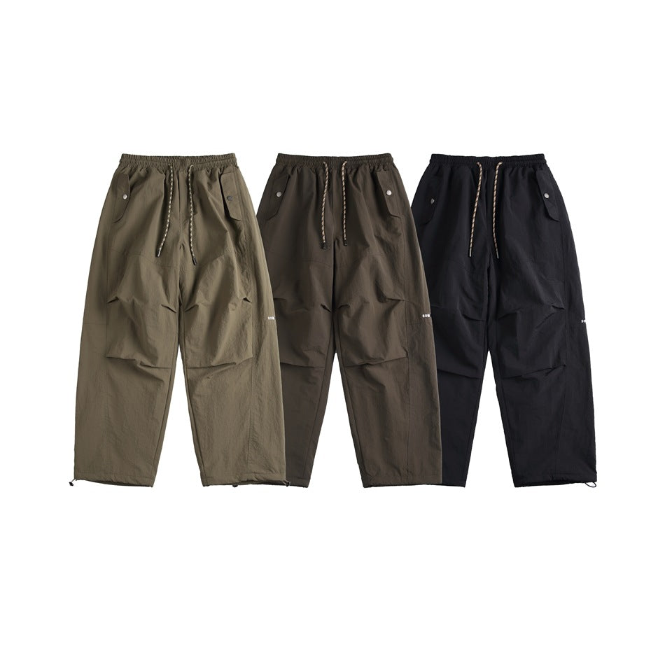 Three pairs of cargo pants shown from the front in olive, dark brown, and black.