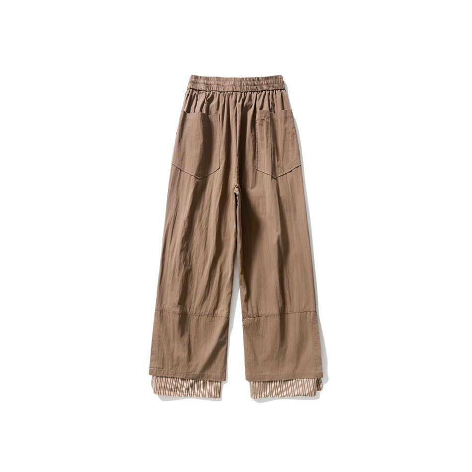 Back view of taupe wide-leg trousers with an elastic waist, two patch pockets, and striped fabric at the cuffs.