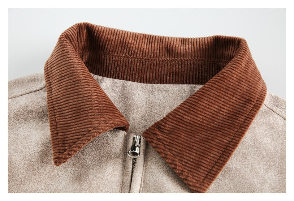 Close-up of a beige mottled jacket's brown ribbed collar and front zipper.