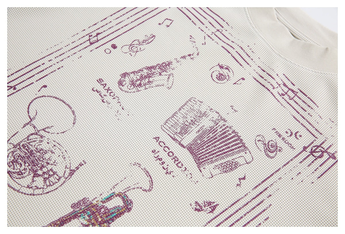 Close-up of an off-white textured shirt with burgundy music-themed illustrations and lettering.