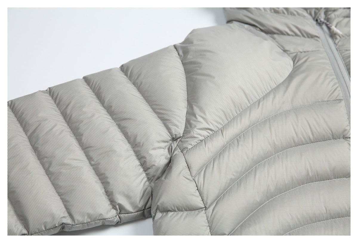 Close-up of the padded sleeve and body panels of a light gray pinstriped jacket.