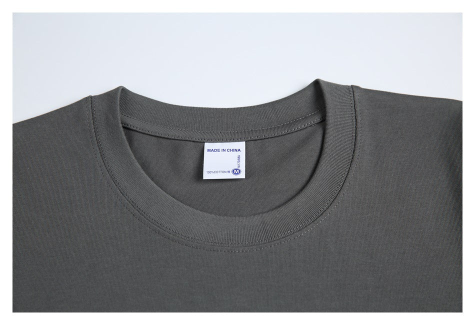 Close-up of the T-shirt's ribbed crew neckline and inner label, which reads Made in China and 100% cotton.