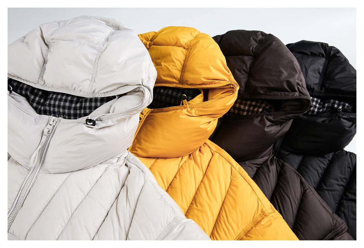 Close-up of hooded puffer jackets in off-white, mustard yellow, dark brown, and black.