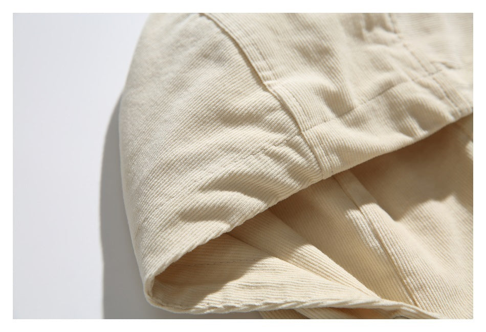 Close-up of the cream jacket hood showing its ribbed fabric texture and stitched seams.