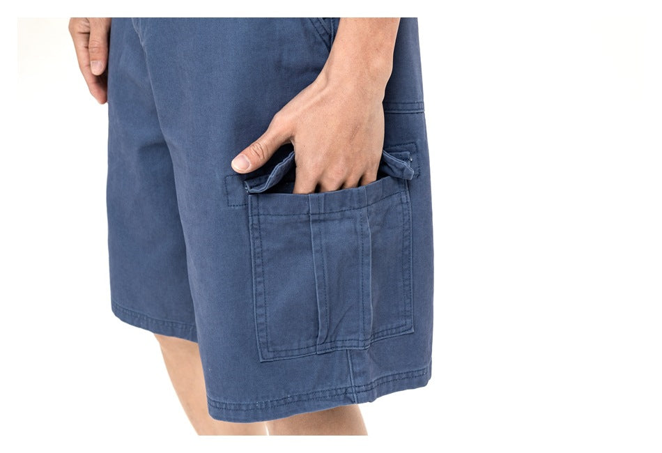 Close-up of blue cargo shorts showing a large stitched side pocket with a flap.
