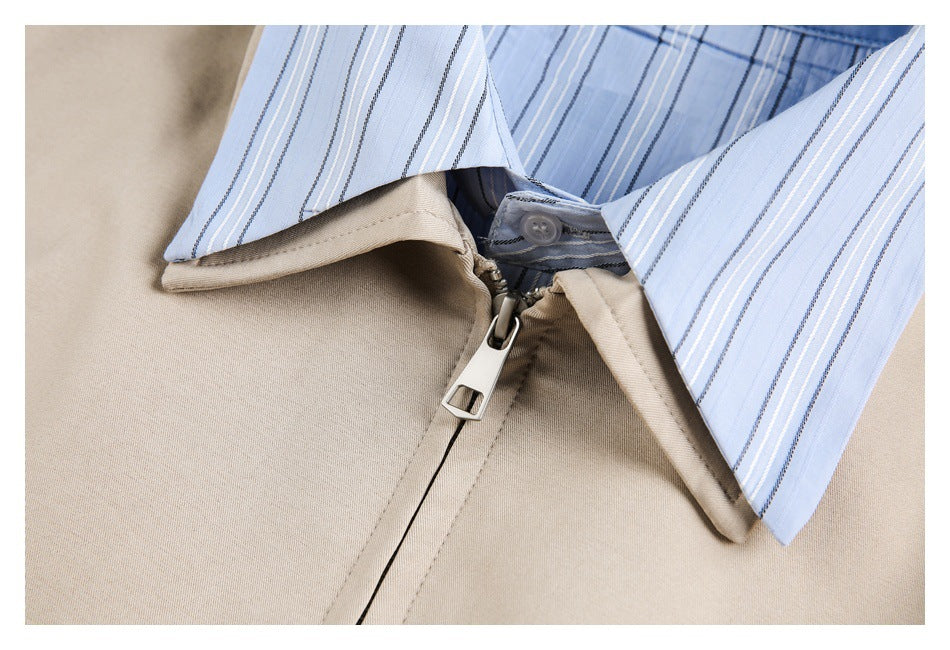 Close-up of a beige jacket collar, zipper, and light blue striped inner collar.