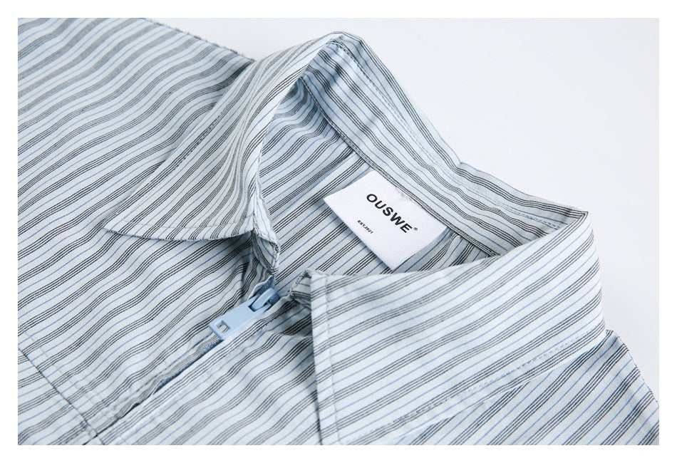 Close-up of a blue-gray striped shirt collar, front closure, and sewn-in OUSWE label.