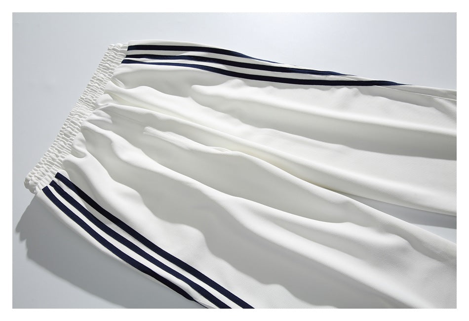 White trousers shown flat with an elastic waistband and navy side stripes.