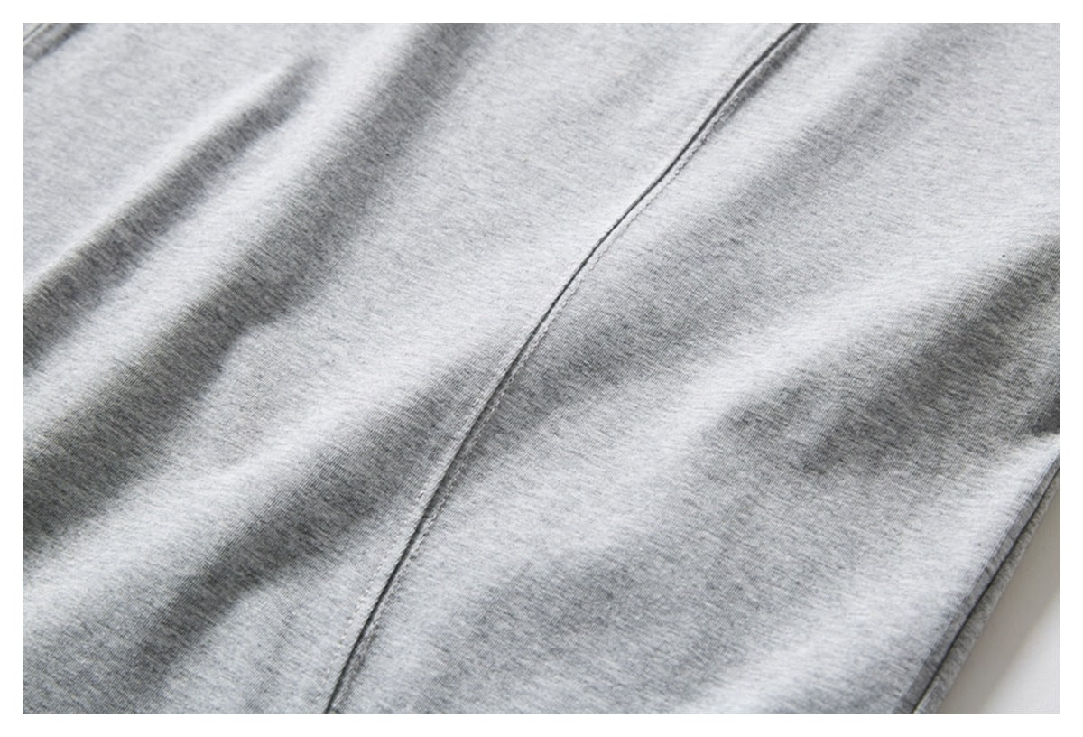 Close-up of heather gray T-shirt fabric with a vertical seam.