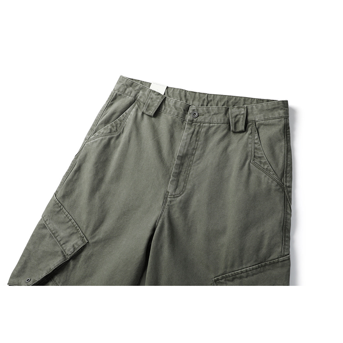 Close-up front view of olive-gray cargo pants showing the waistband, button closure, slanted pockets and flap cargo pockets.
