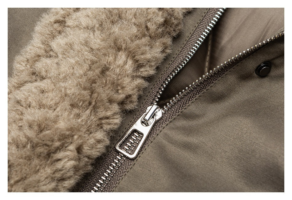 Close-up of a silver zipper beside plush beige lining on a taupe-brown garment.