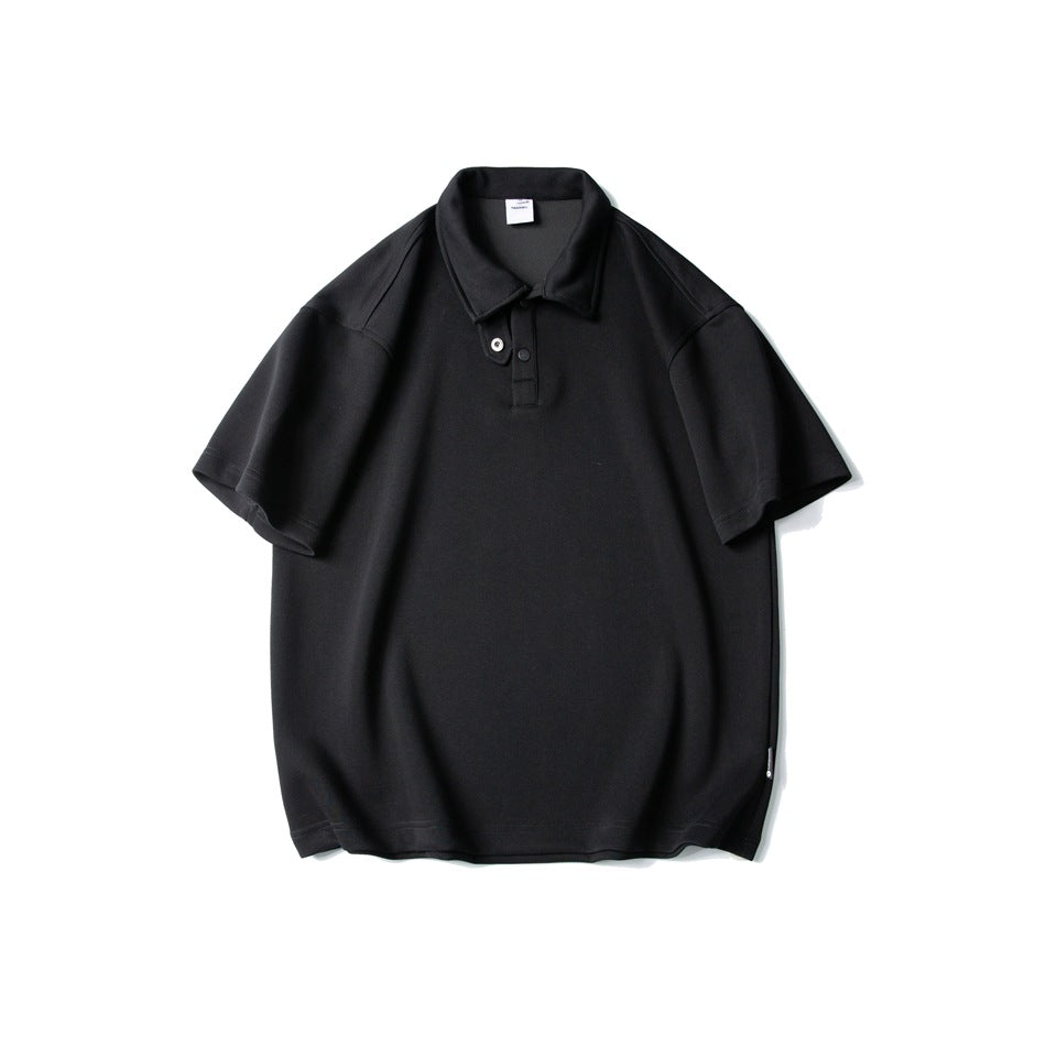 Black short-sleeve polo shirt flat lay, front view, with folded collar, two snap buttons and drop shoulders